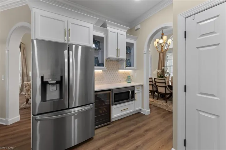 Wine fridge next to refrigerator
