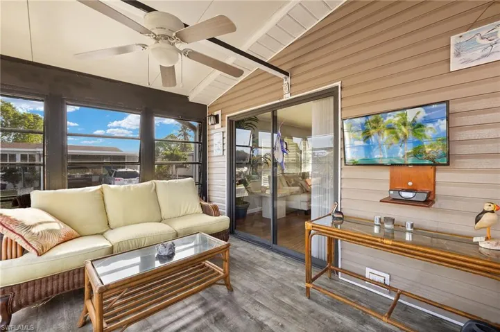 Sunroom / solarium with vaulted ceiling with beams and ceiling fan