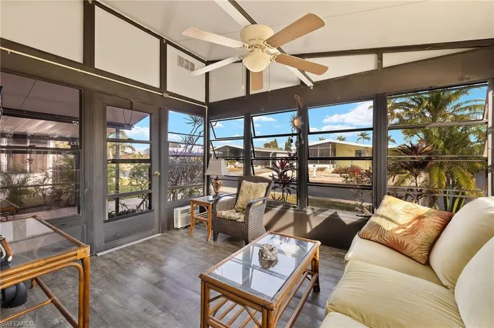 Sunroom with ceiling fan and vaulted ceiling