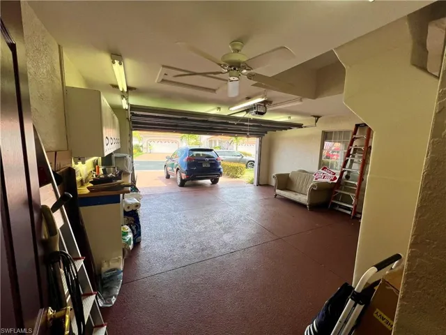 Garage featuring a ceiling fan and a garage door opener