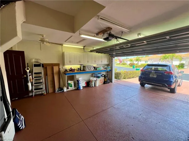 Garage with ceiling fan and a garage door opener