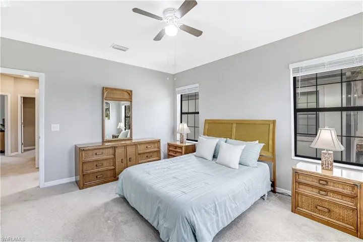 Primary Bedroom with crown molding, and ceiling fan with ensuite bathroom and large walk-in closet