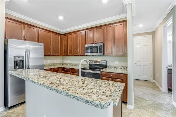 Kitchen featuring all granite countertops and stainless tell appliances.