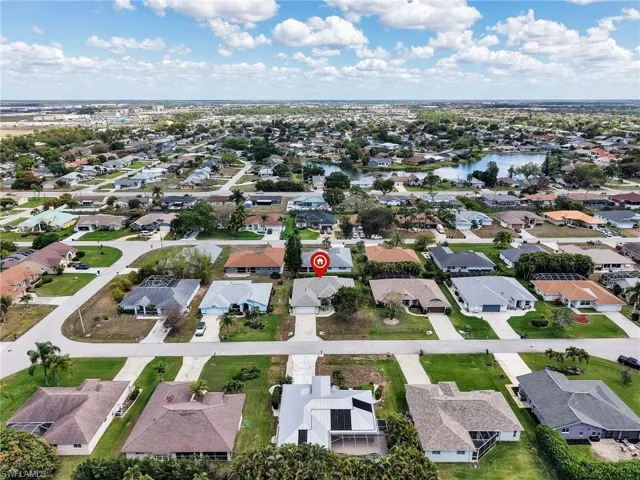 Aerial perspective of suburban area with a large body of water