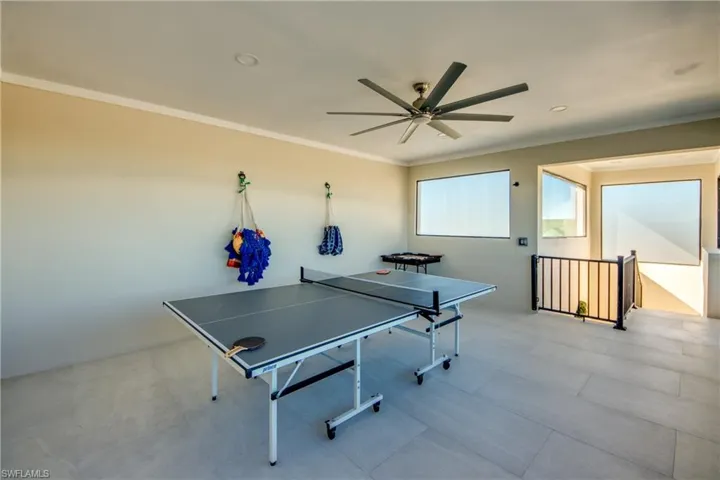 Game room with ornamental molding, ceiling fan, and recessed lighting