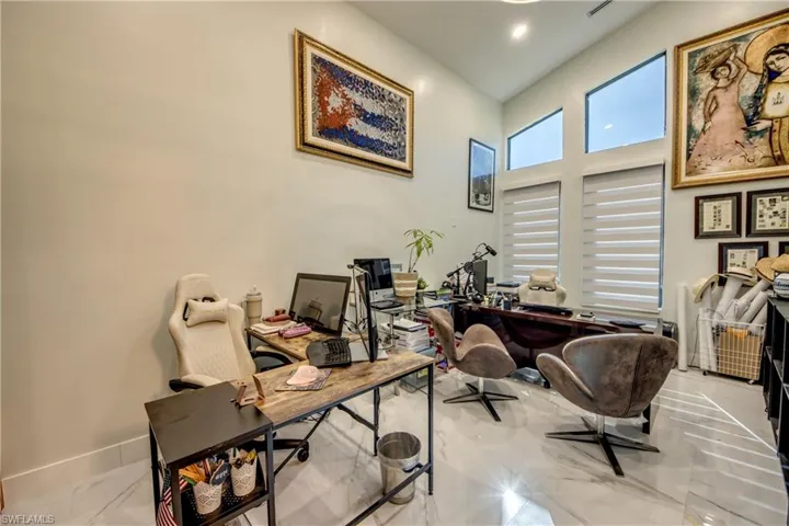 Office space with a towering ceiling and marble finish flooring