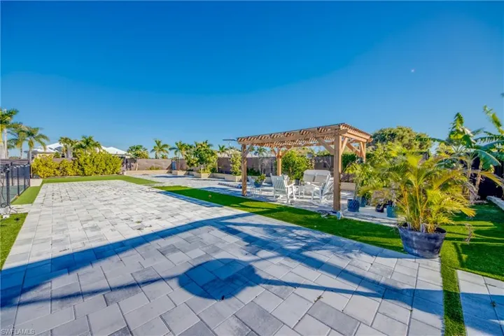 View of property's community featuring a patio area, a pool, a pergola, and a fenced backyard