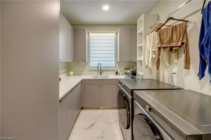 Kitchen with open shelves, light marble finish flooring, separate washer and dryer, light countertops, and recessed lighting