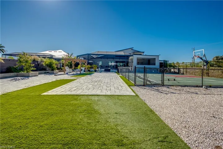 Surrounding community featuring a gate, a patio area, a pergola, and community basketball court