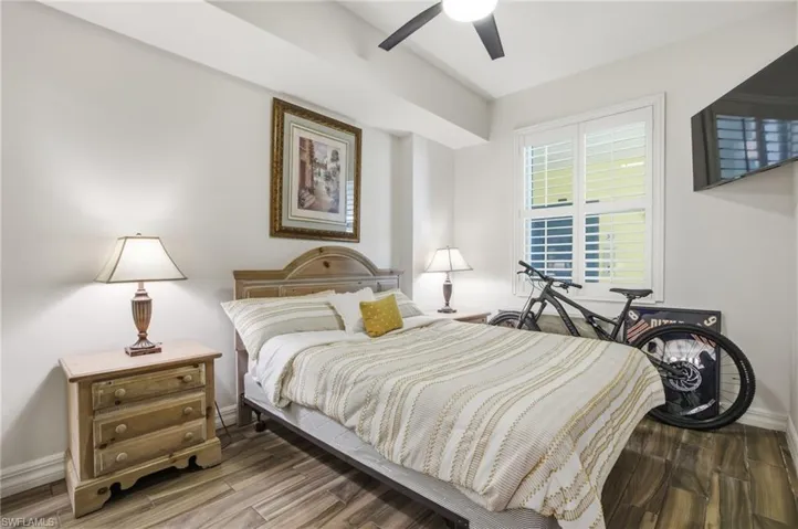 Bedroom with wood finished floors and ceiling fan