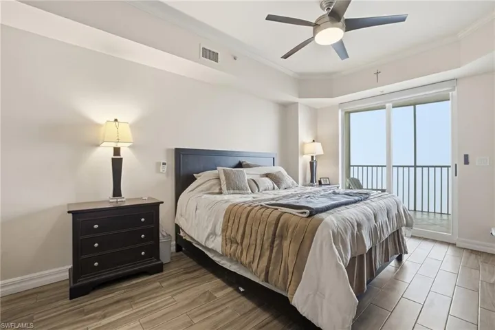 Bedroom with wood finish floors, crown molding, access to outside, and a ceiling fan