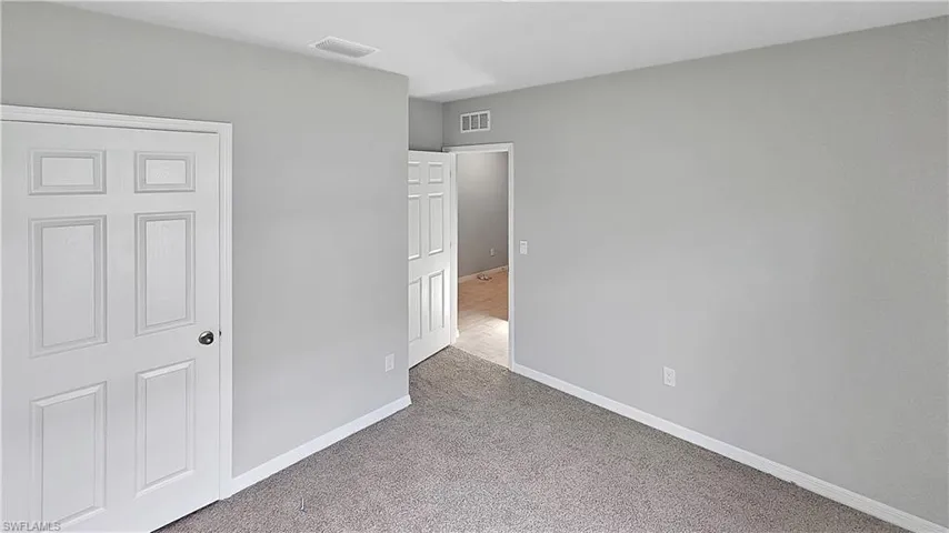 Empty room with carpet floors