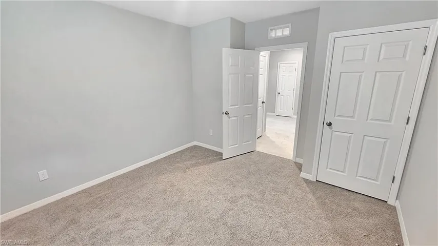 Unfurnished bedroom with light carpet