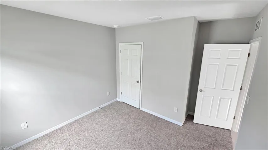 Unfurnished bedroom with carpet