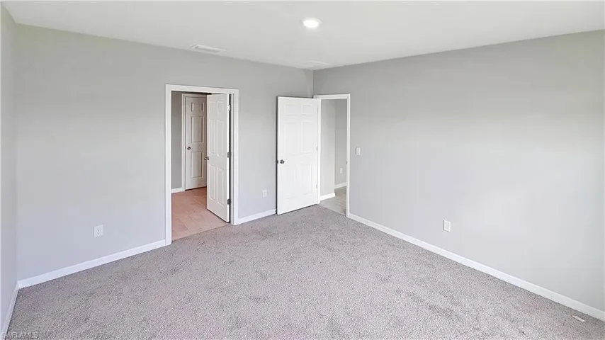 Unfurnished bedroom with carpet flooring