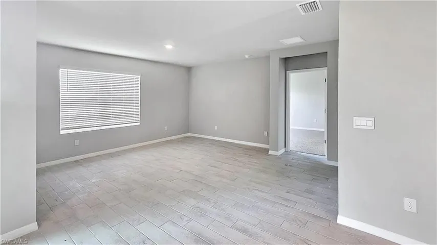 Empty room with light hardwood / wood-style floors