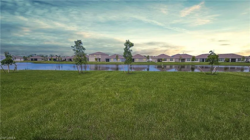 Yard at dusk featuring a water view