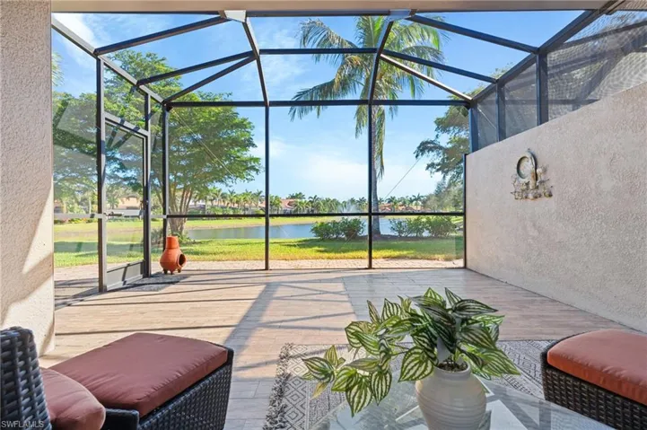 View of patio / terrace featuring a water view and a lanai