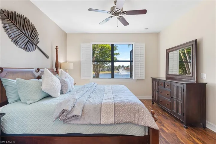 Bedroom with ceiling fan and dark hardwood / wood-style flooring