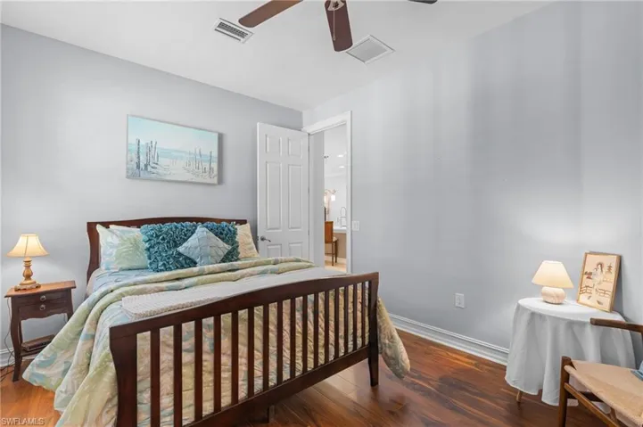 Bedroom with ceiling fan and dark hardwood / wood-style flooring