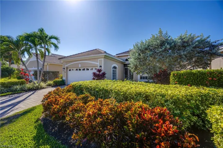 View of front of property featuring stucco siding, an attached garage, decorative driveway, and a tiled roof