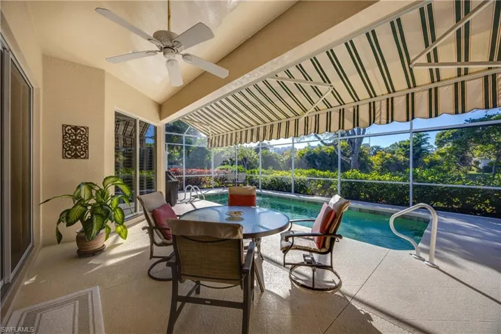 View of patio with a lanai, an outdoor pool, and ceiling fan