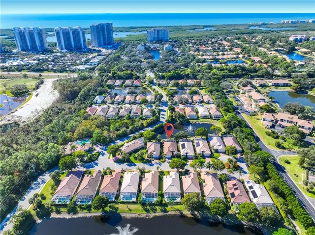 Aerial view of property's location featuring a large body of water and nearby suburban area