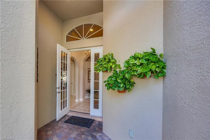 Entrance to property featuring stucco siding