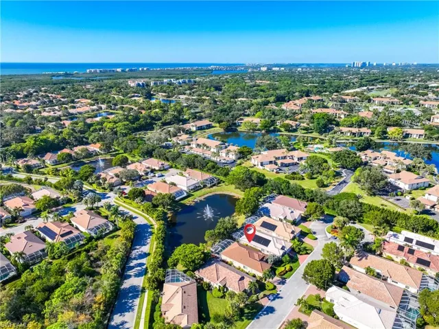 Aerial overview of property's location with a large body of water and nearby suburban area