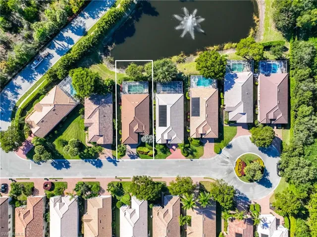 Aerial perspective of suburban area featuring a nearby body of water