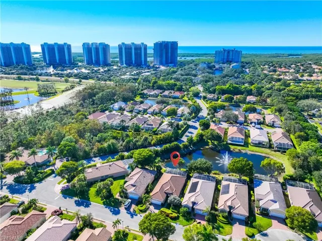 Aerial perspective of suburban area featuring a nearby body of water
