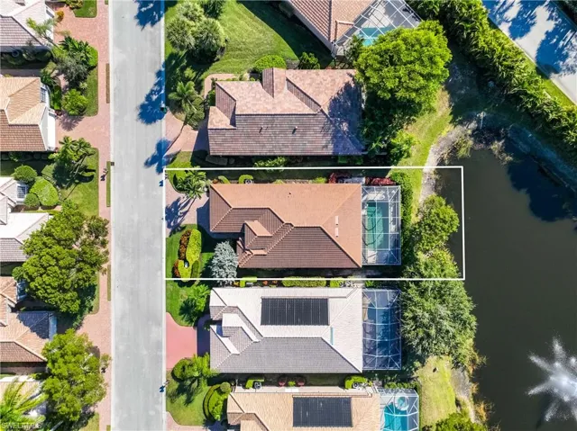 Aerial perspective of suburban area featuring a nearby body of water and property parcel outlined