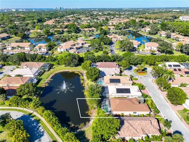 Aerial perspective of suburban area featuring a nearby body of water and property parcel outlined