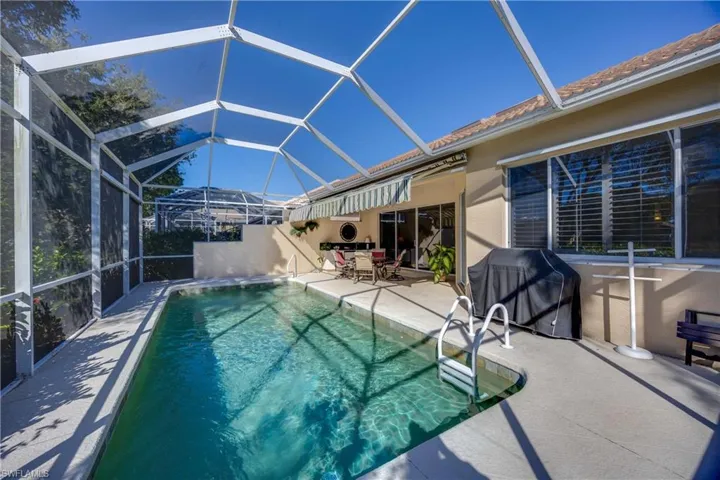 Outdoor pool with lanai a patio, and room for grilling