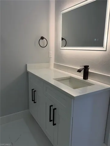 Bathroom with vanity and baseboards