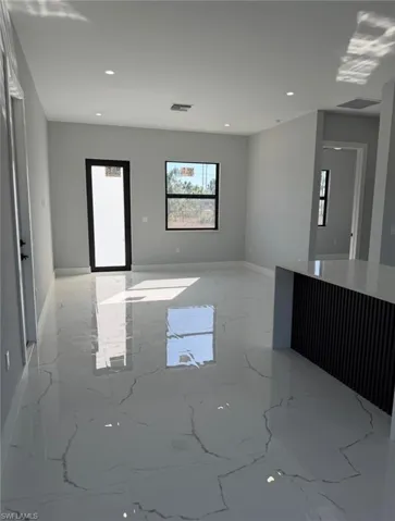 Spare room with light marble finish floors and recessed lighting