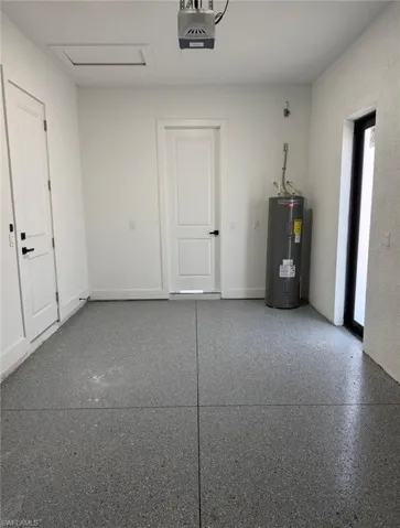 Garage with water heater and a garage door opener