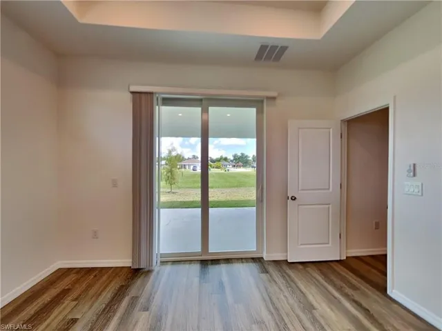 Picture of a previously completed home Unfurnished room with wood finished floors and baseboards