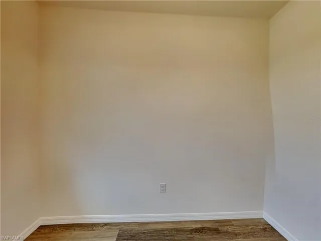 Picture of a previously completed home Spare room with baseboards and wood finished floors