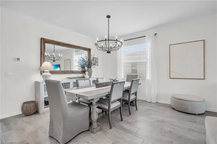 Dining space featuring ornamental molding and a chandelier