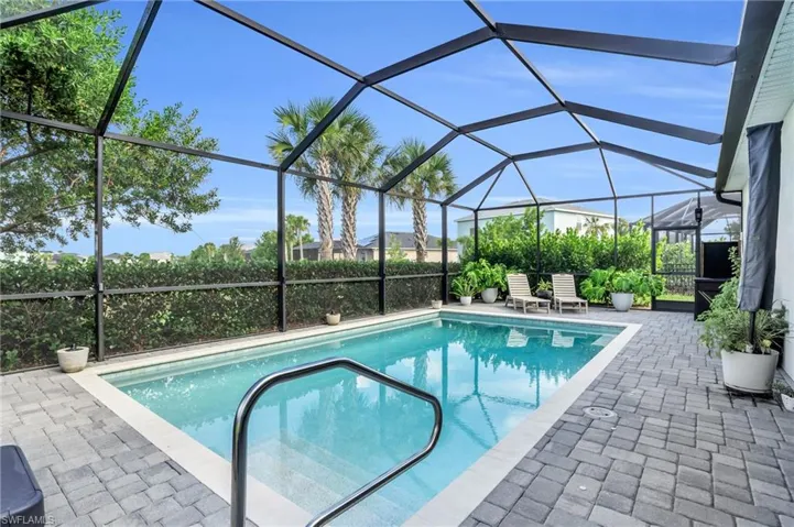View of pool with a lanai and a patio area