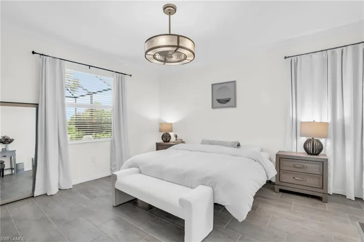 Master Bedroom with crown molding and an inviting chandelier