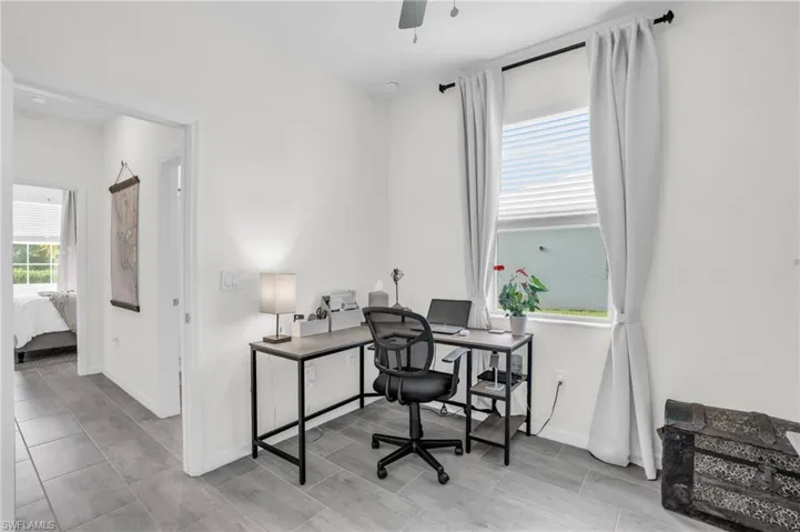 Bedroom 1/Office area featuring ceiling fan
