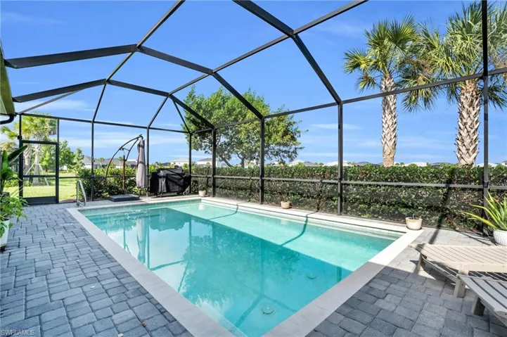 View of swimming pool with a patio area and a lanai