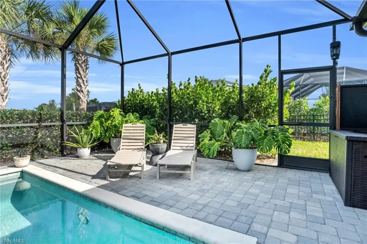 View of swimming pool with a lanai and a patio area