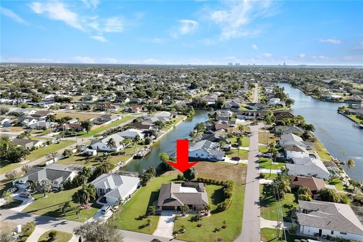 Aerial view of property's location with nearby suburban area and a large body of water