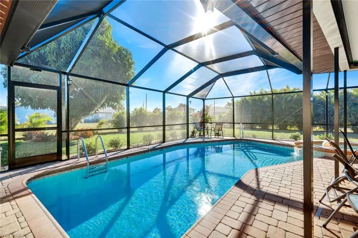 Outdoor pool featuring a lanai, a sunroom, and a patio