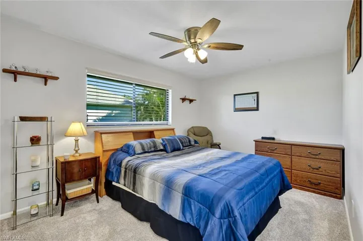 Bedroom featuring a ceiling fan and carpet floors