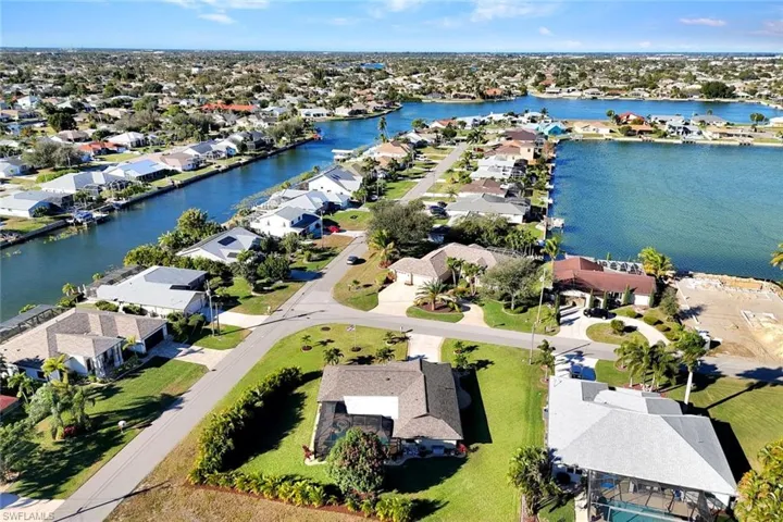 Aerial view of residential area featuring a nearby body of water