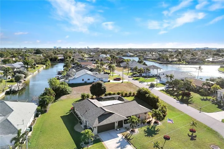 Aerial view of residential area featuring a nearby body of water